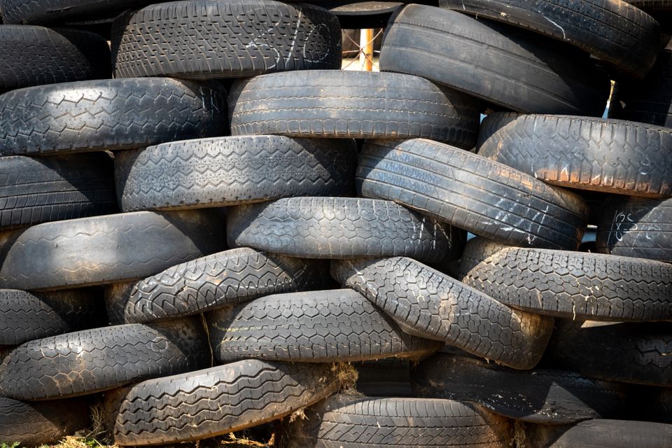 Stacked vehicle tyres at industrial lot